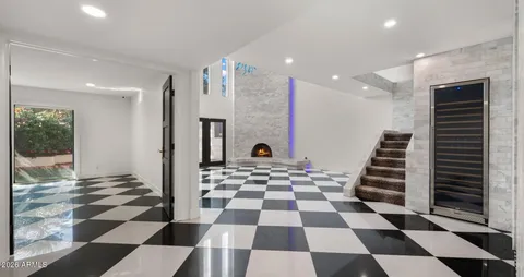 a black and white checkered floor with a rug