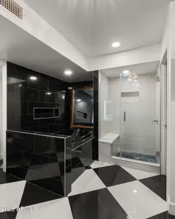 a bathroom with a double vanity sink and mirror