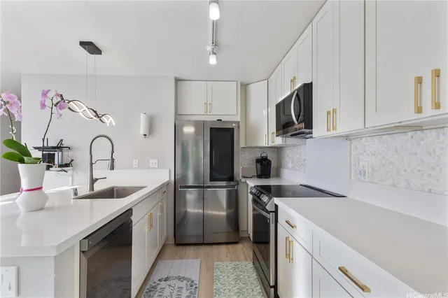a kitchen with stainless steel appliances granite countertop a sink stove and refrigerator