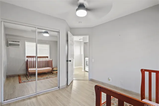 a view of a hallway with wooden floor and chair