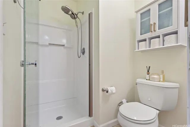 a white toilet sitting next to a bathroom sink