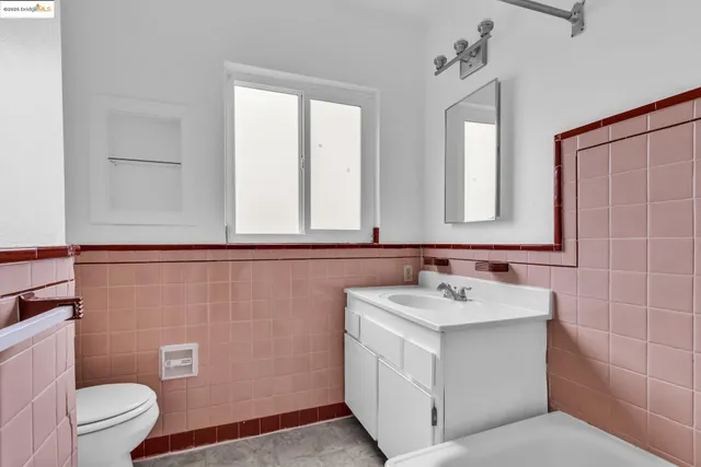 a bathroom with a sink toilet and mirror