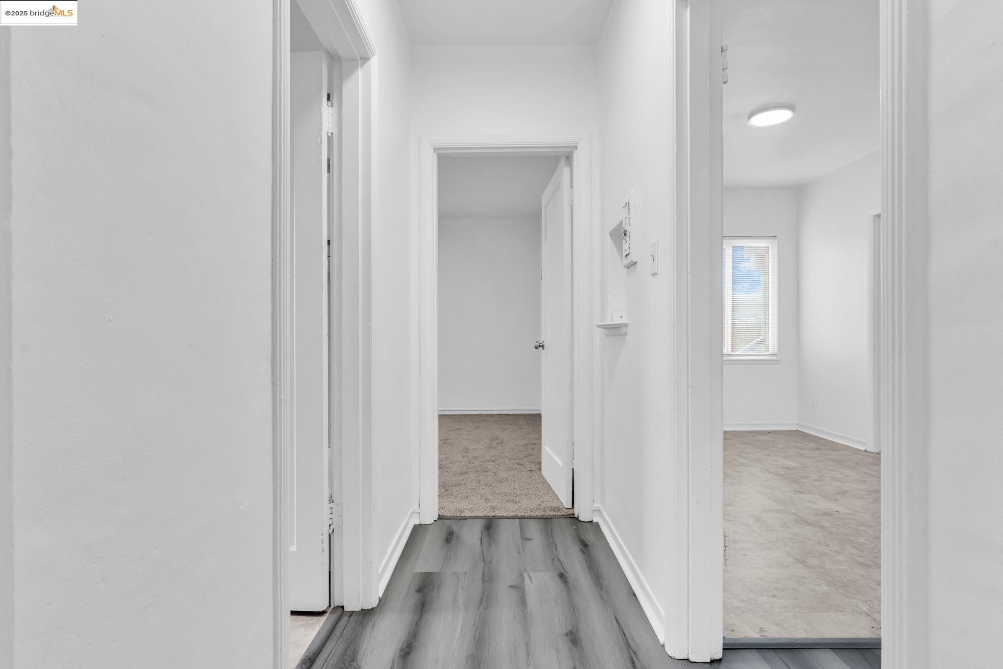 5492 Ruth Avenue Oakland, CA 94601 - Photo 16 of 16 Corridor featuring light wood finished floors and baseboards