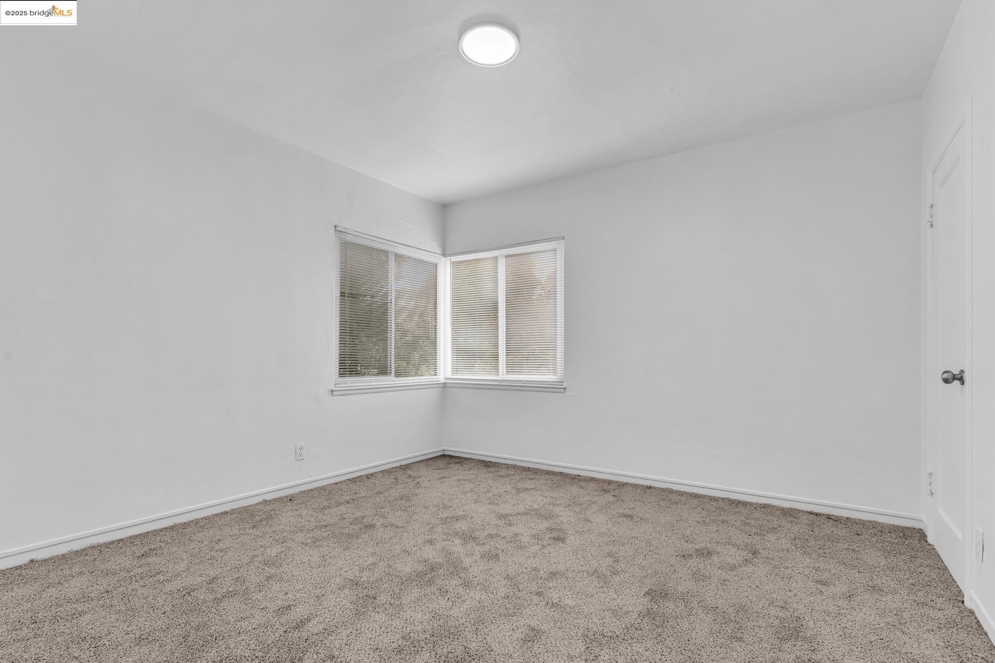 5492 Ruth Avenue Oakland, CA 94601 - Photo 5 of 16 Unfurnished room with light carpet and baseboards