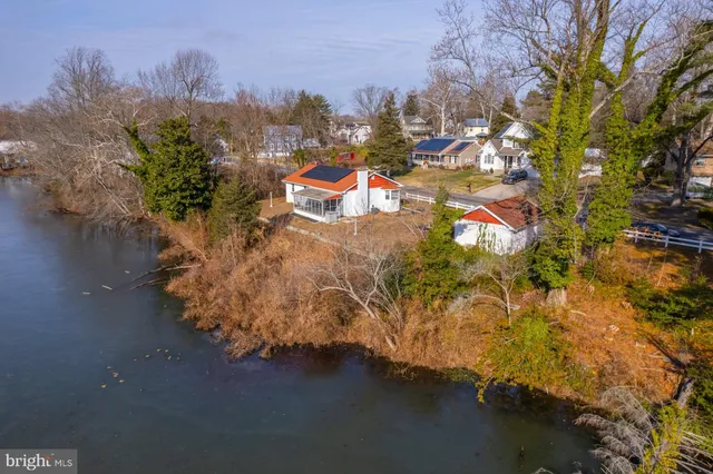 an aerial view of a house with a yard basket ball court