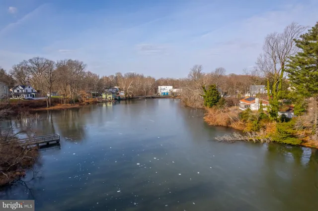 a kitchen with stainless steel appliances granite countertop a stove a sink dishwasher a refrigerator and cabinets with wooden floor