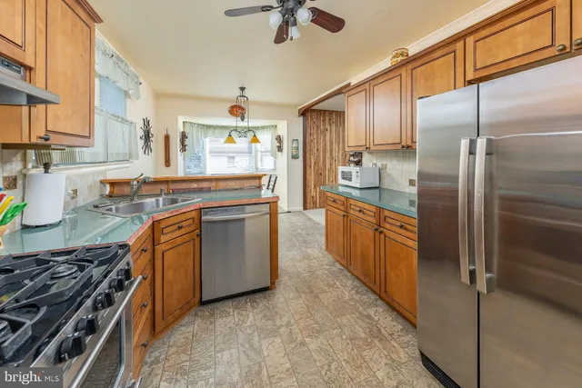 a view of a dining room with furniture and a chandelier