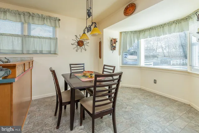 a view of an empty room with a window and a livingroom