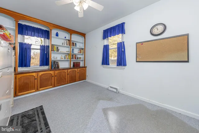 a bathroom with a toilet sink vanity granite and a mirror