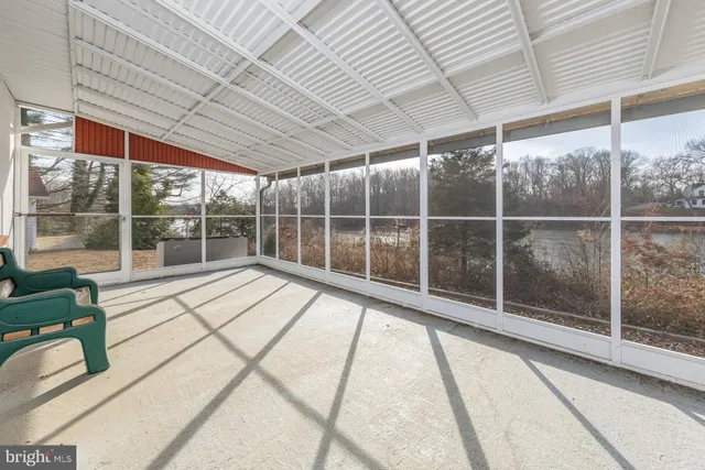 a view of a room with wooden floor and iron stairs