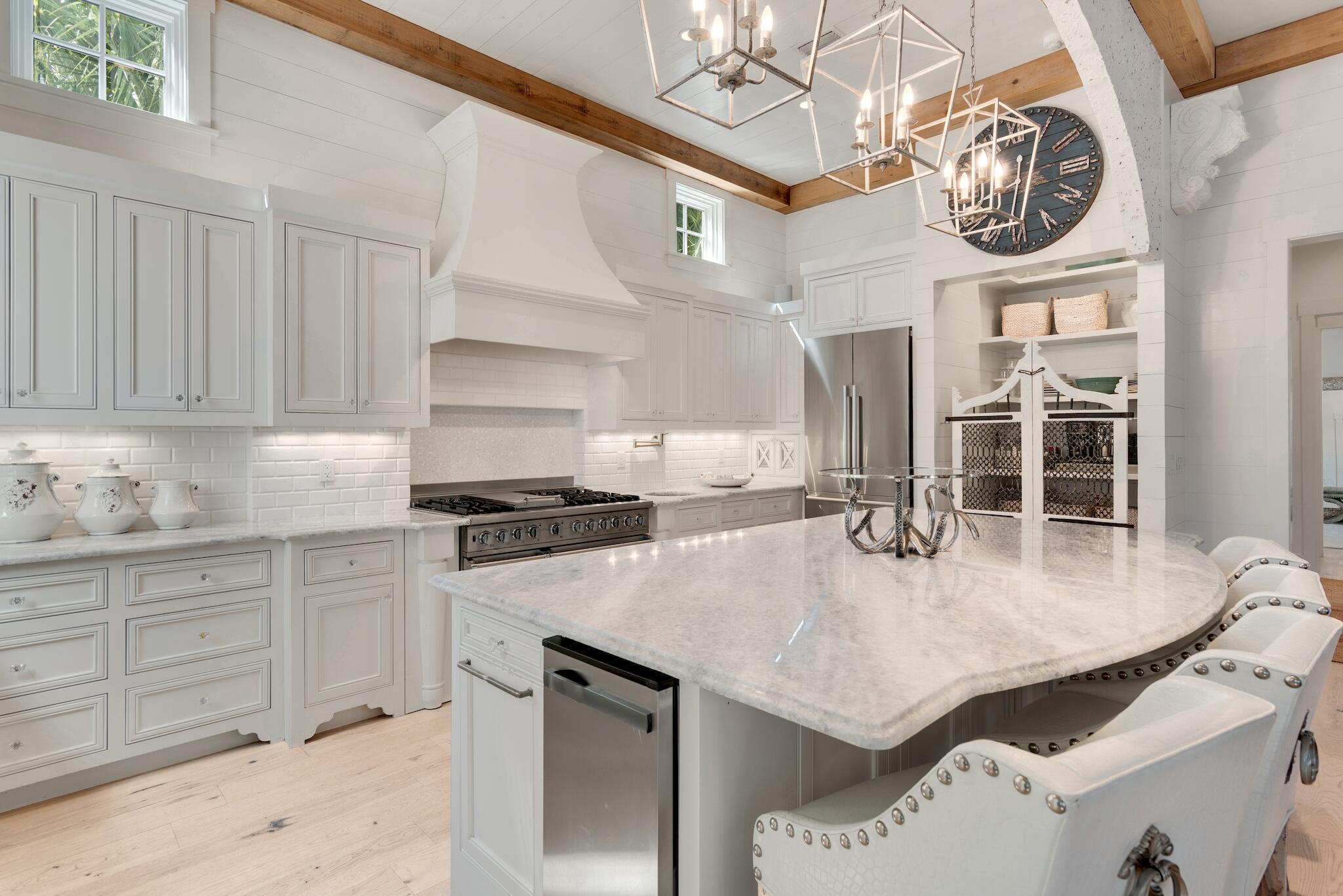 44 Tidepool Lane Watersound, FL 32461 - Photo 11 of 34 a kitchen with stainless steel appliances granite countertop a stove a sink and a refrigerator