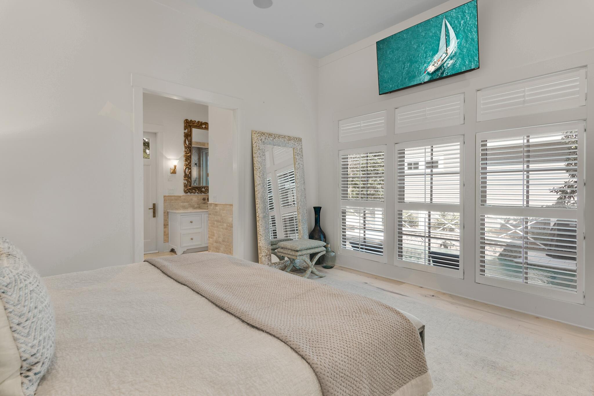 44 Tidepool Lane Watersound, FL 32461 - Photo 14 of 34 a large bedroom with a bed and large windows