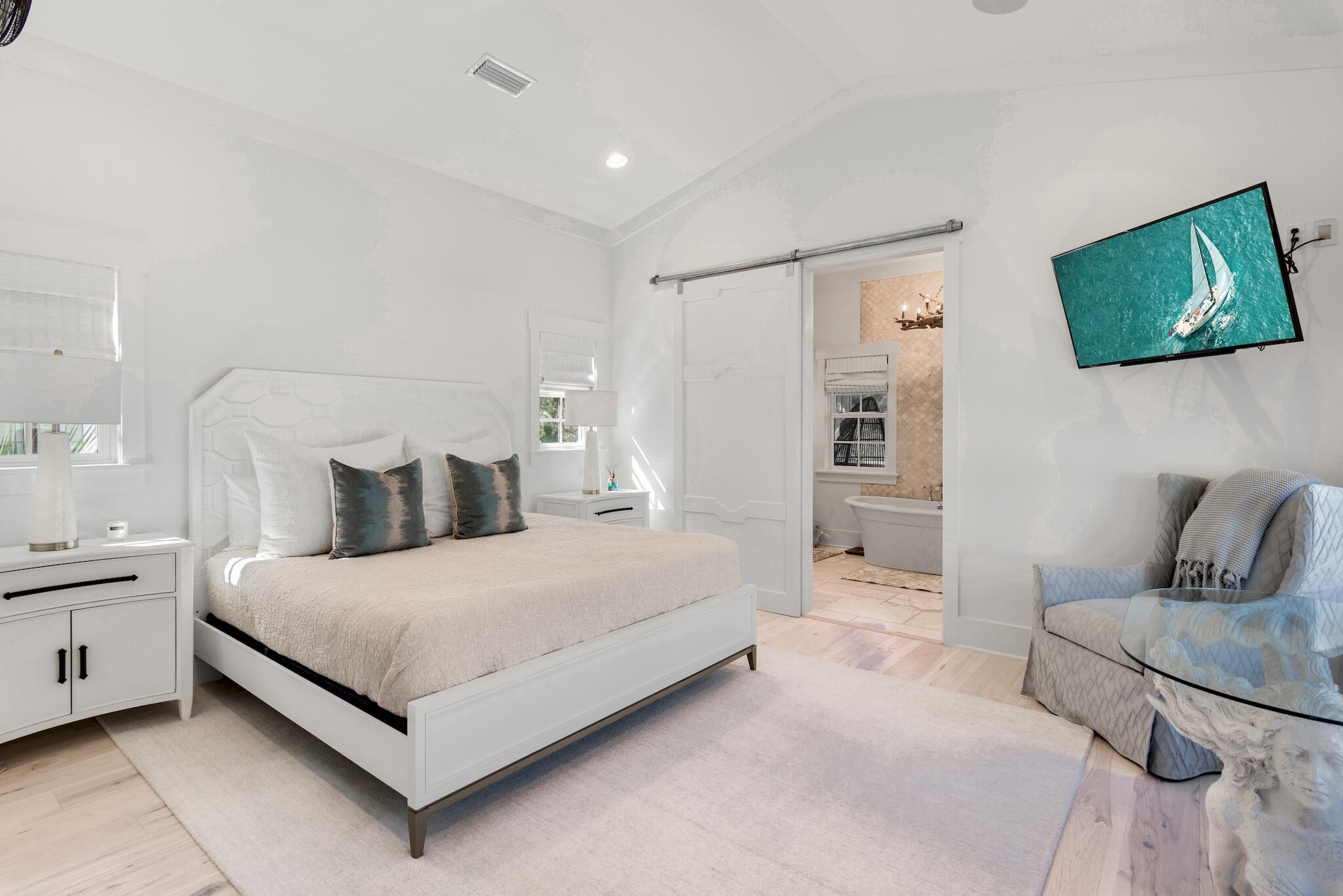 44 Tidepool Lane Watersound, FL 32461 - Photo 18 of 34 a bedroom with a bed and glass wall