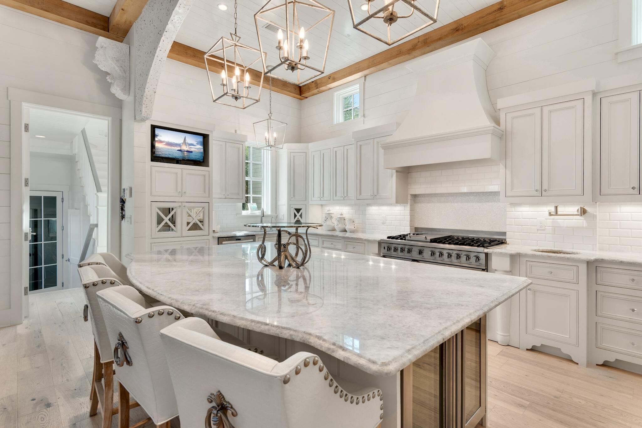 44 Tidepool Lane Watersound, FL 32461 - Photo 6 of 34 a kitchen with stainless steel appliances granite countertop a sink a stove and chairs