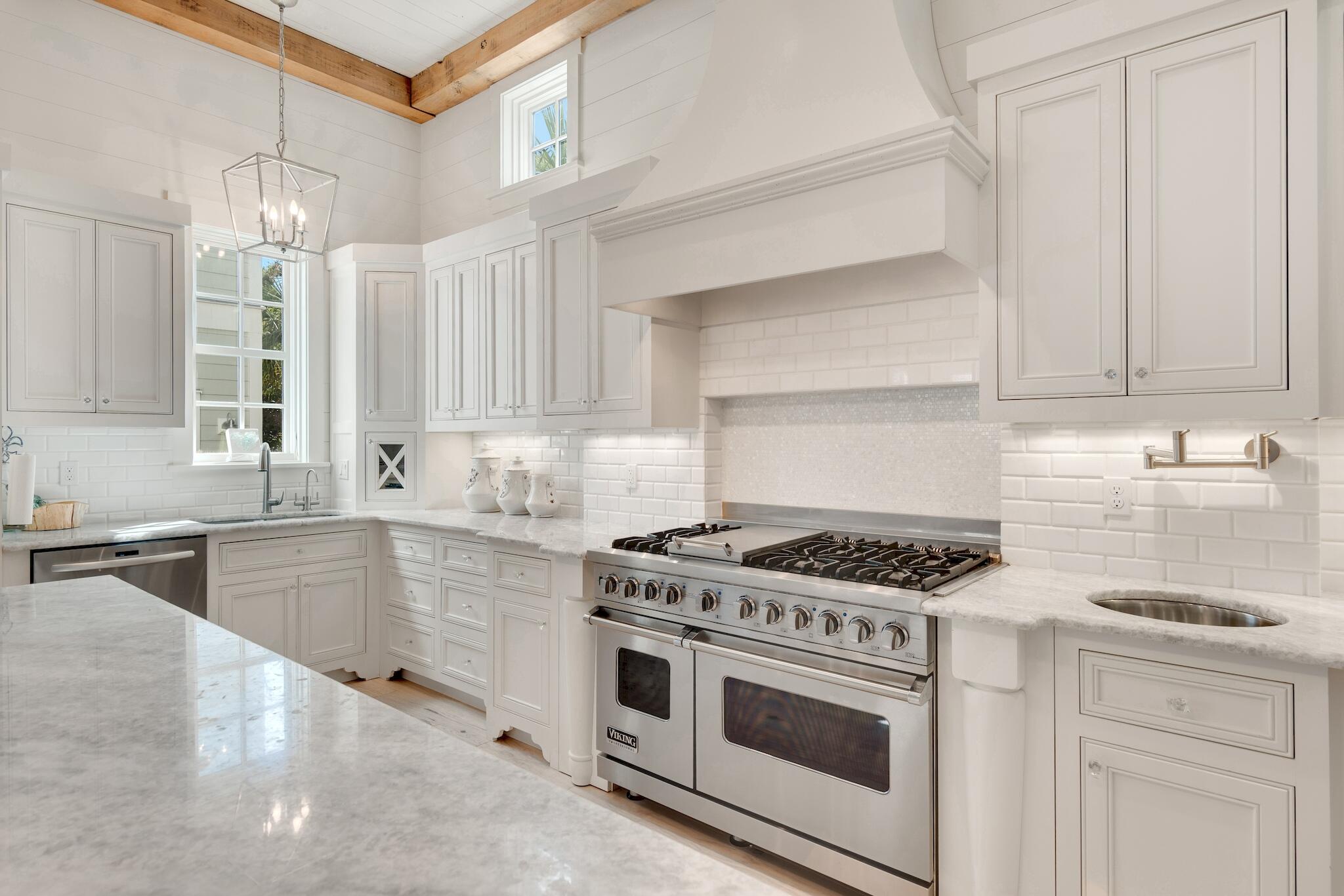 44 Tidepool Lane Watersound, FL 32461 - Photo 10 of 34 a kitchen with stainless steel appliances granite countertop white cabinets and window