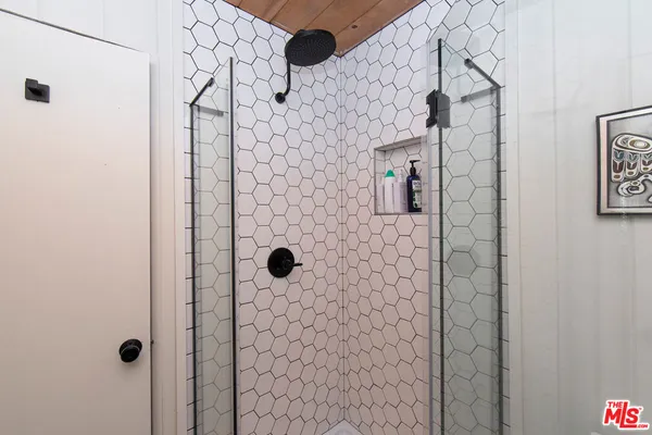 a bedroom with a bed and a mirror