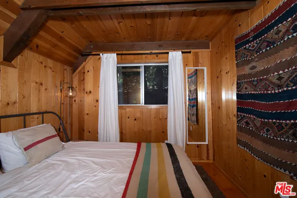 a view of a room with wooden floor and furniture