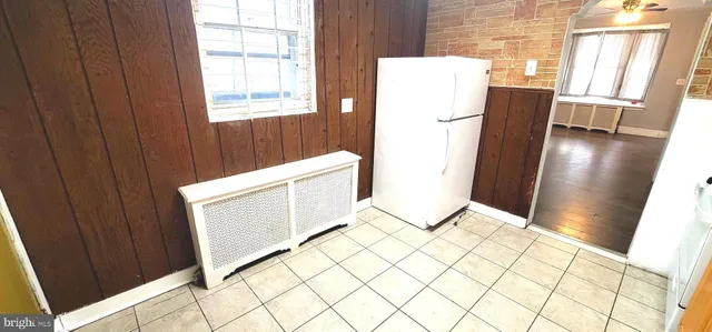 a view of kitchen with window and refrigerator