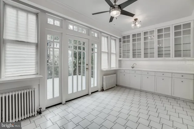 a view of a big room with windows and furniture