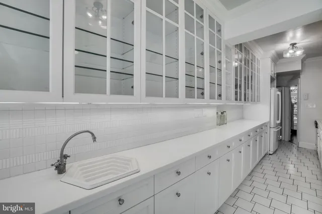 a kitchen with stainless steel appliances a sink a stove and cabinets