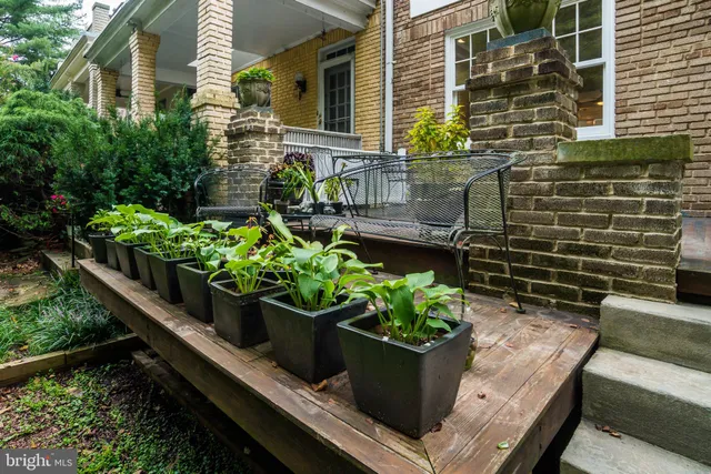 a wooden bench sitting in front of a house