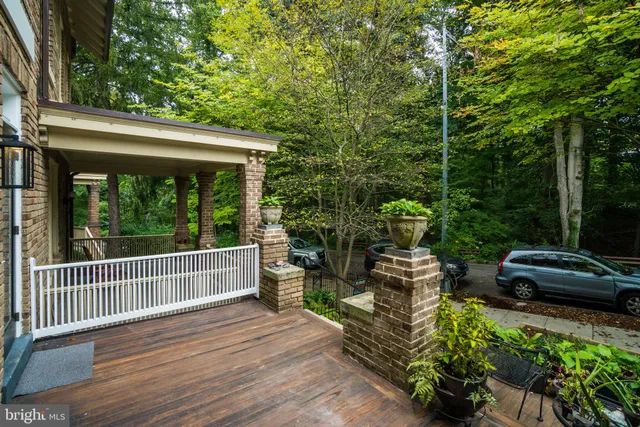 a view of a deck with couches table and chairs and wooden floor