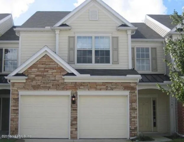 a view of a big room with wooden floor and windows