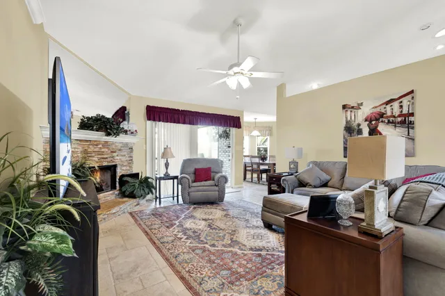 a living room with furniture fireplace and flat screen tv