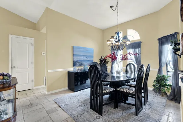 a dining room with furniture and window