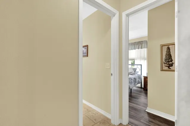 a view of a hallway with wooden floor and closet
