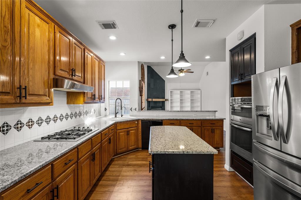 3901 Caney Creek Road Austin, TX 78732 - Photo 5 of 18 Center island, stainless appliances. Kitchen opens to the family room. Gas cooking. There is also a large walk-in pantry.