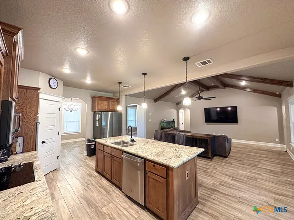 a living room with a flat screen tv and a wooden floor