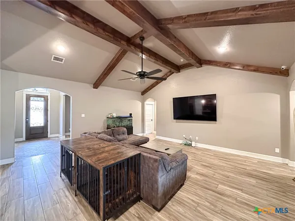 a bedroom with a bed and a ceiling fan