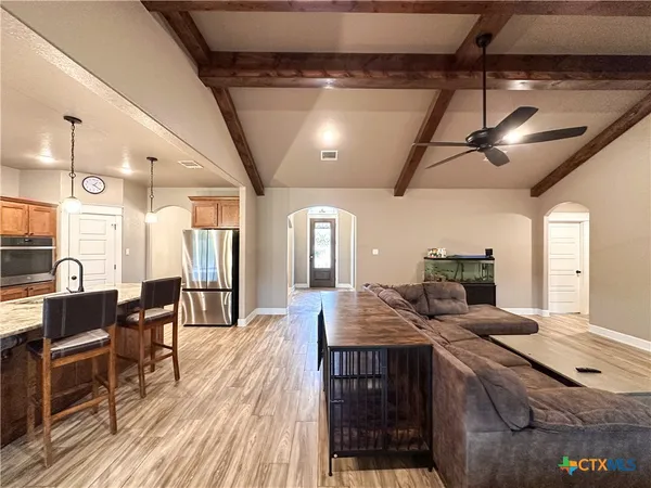 a large bathroom with a tub double sink and a large mirror
