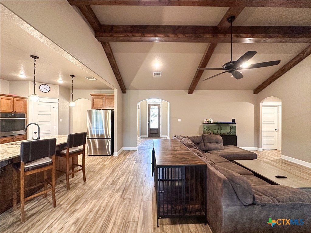 3533 Hooten Bend Kempner, TX 76539 - Photo 17 of 47 a kitchen with stainless steel appliances granite countertop a stove a sink dishwasher and a dining table with wooden floor