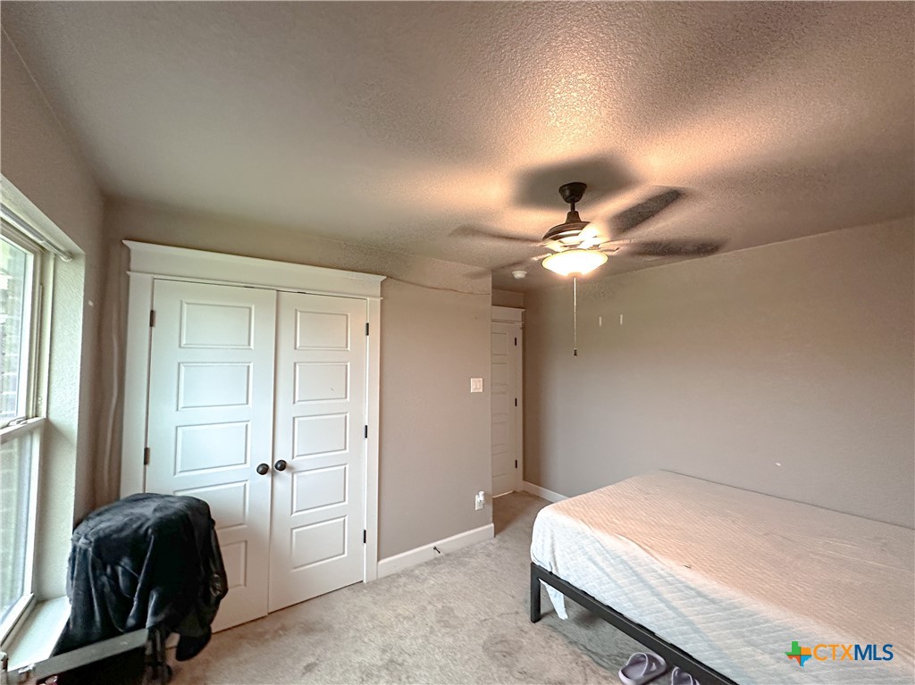 3533 Hooten Bend Kempner, TX 76539 - Photo 35 of 47 a bedroom with a bed and a chandelier