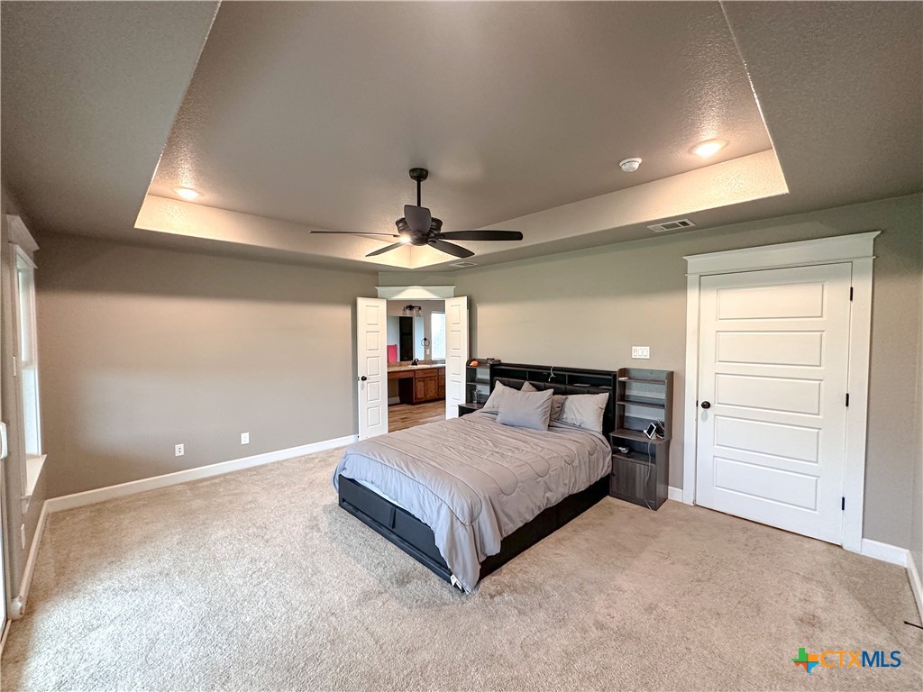 3533 Hooten Bend Kempner, TX 76539 - Photo 43 of 47 a spacious bedroom with a bed and a chandelier
