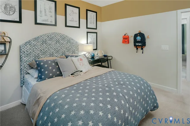 a bedroom with a bed and painting on the wall