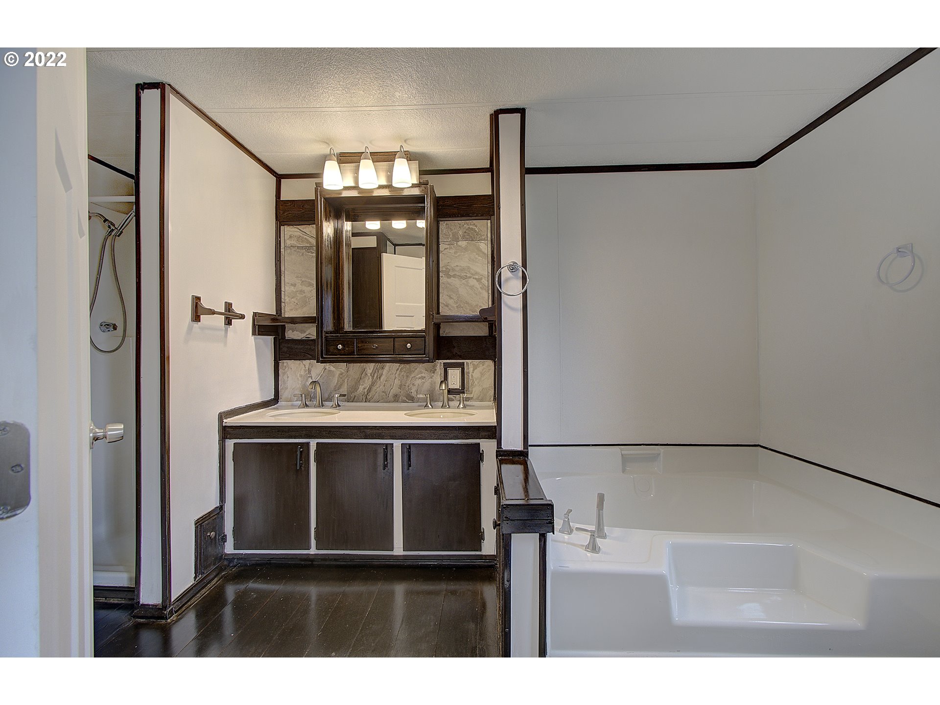 15619 Northeast Caples Road, Unit 104 Brush Prairie, WA 98606 - Photo 19 of 22 a bathroom with a sink and a mirror