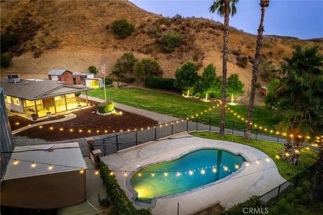 a view of a swimming pool with a yard