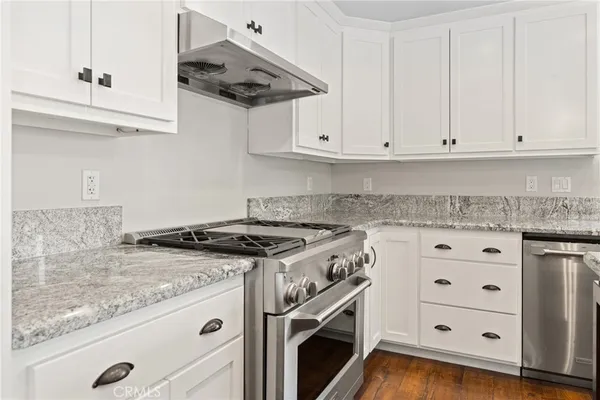 a bathroom with a granite countertop toilet sink and mirror