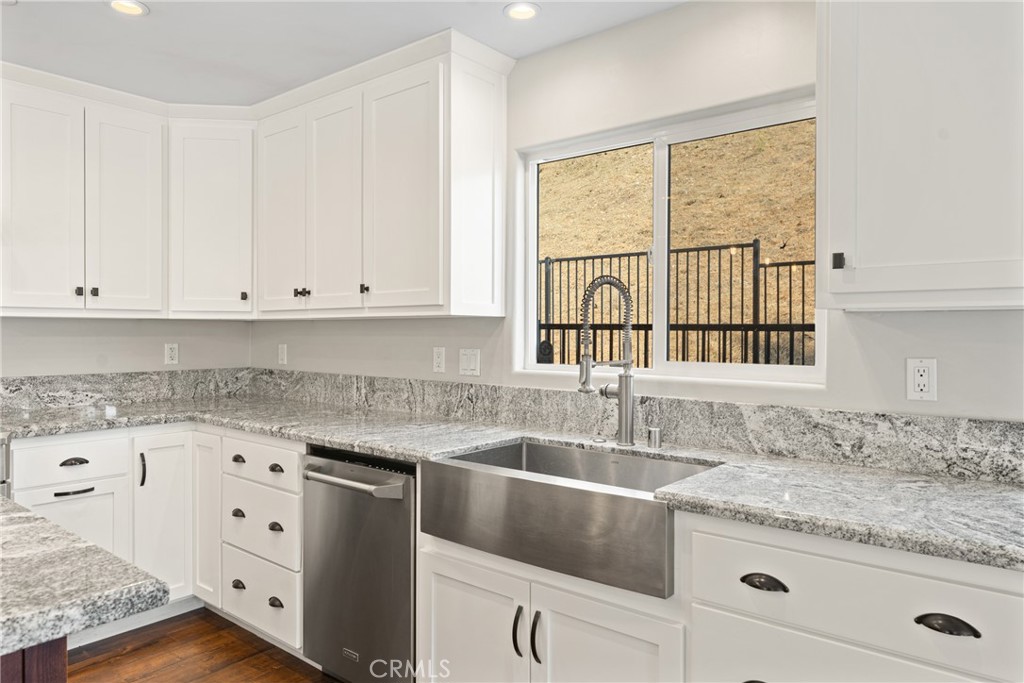 30300 Live Oak Canyon Road Redlands, CA 92373 - Photo 23 of 67 a kitchen with granite countertop white cabinets and a sink