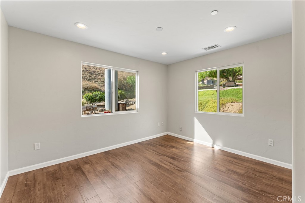 30300 Live Oak Canyon Road Redlands, CA 92373 - Photo 24 of 67 an empty room with wooden floor and windows