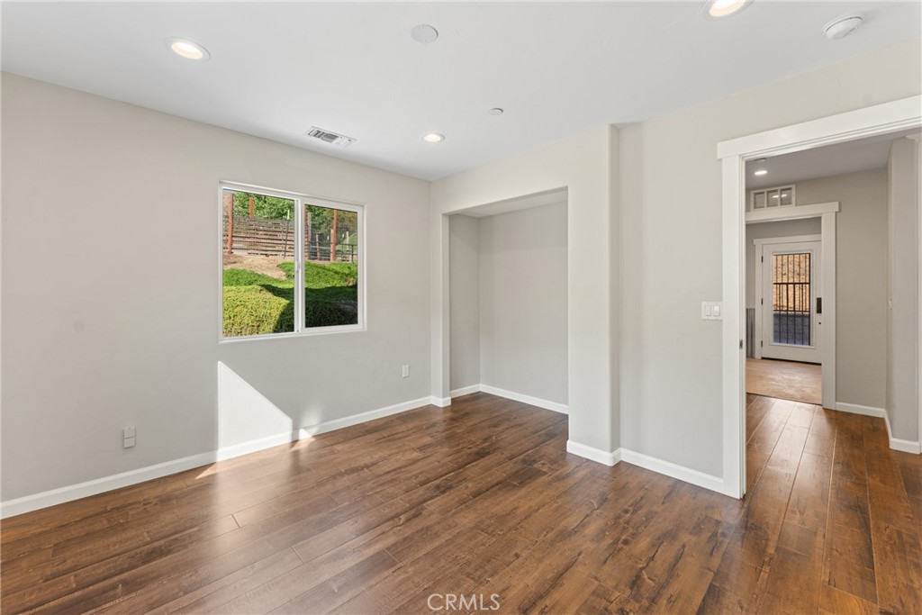 30300 Live Oak Canyon Road Redlands, CA 92373 - Photo 25 of 67 wooden floor in an empty room with a window