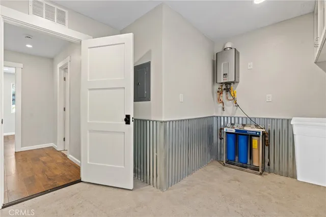 a kitchen with stainless steel appliances granite countertop a sink a stove and a refrigerator