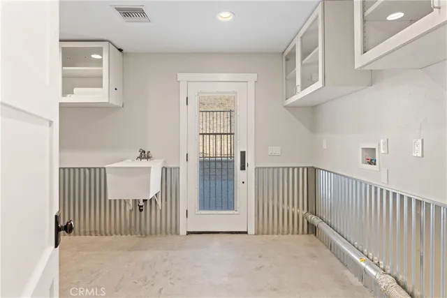 a kitchen with stainless steel appliances kitchen island granite countertop a stove a sink dishwasher a dining table and chairs with wooden floor