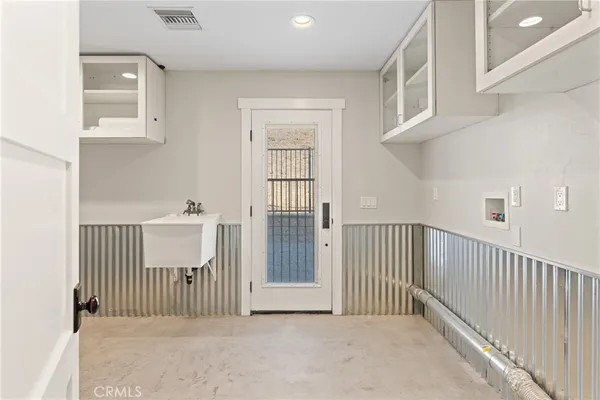 a kitchen with granite countertop stainless steel appliances a stove sink and cabinets