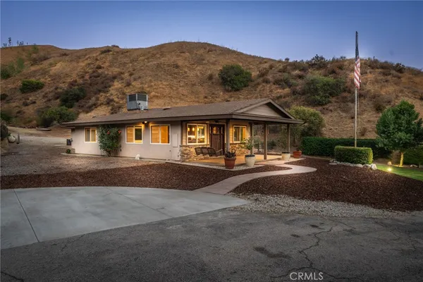 a view of a house with pool and chairs