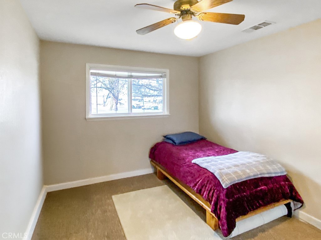 907 Ball Mountain Little Shasta Road Montague, CA 96064 - Photo 15 of 34 a bedroom with a bed and a chandelier