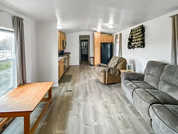 a living room with furniture window and wooden floor